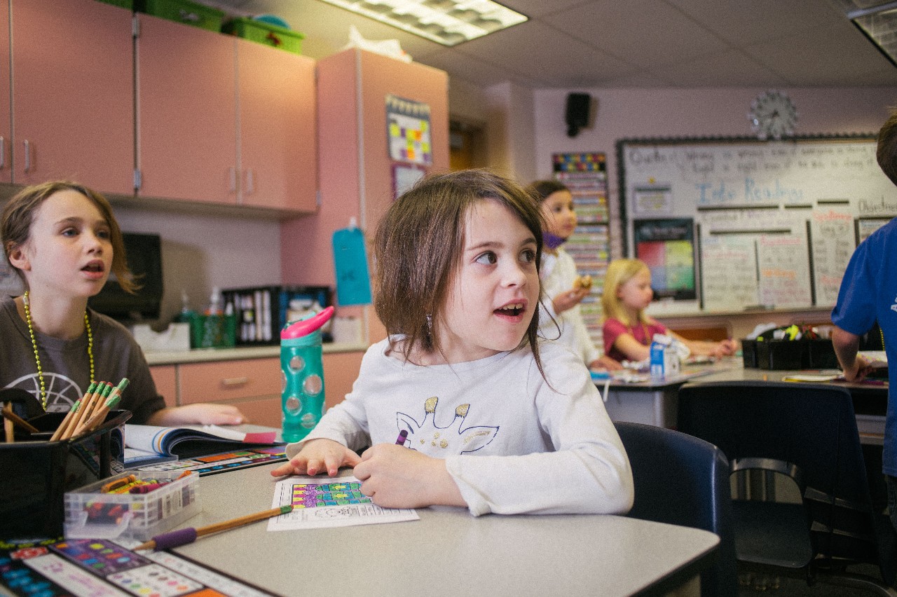 A young student shows her excitement during class.